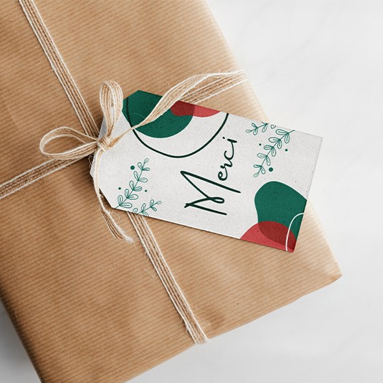 Etiquette américaine perforée personnalisée avec design de Noël attachée à un paquet cadeau