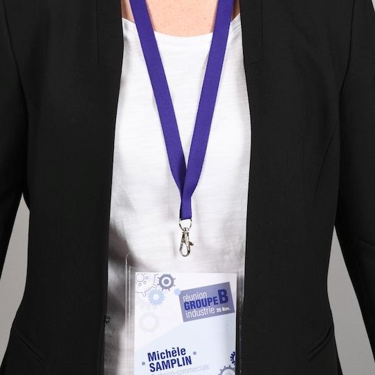 Personne portant un badge évènementiel avec tour de cou violet